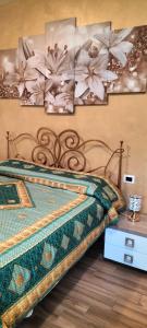 a bedroom with a bed with flowers on the wall at Villa - Malibu' B & B in Lauria