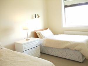 a bedroom with two beds next to a window at Ardeevan Schull in Schull