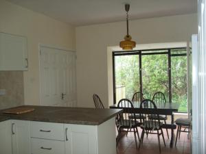 a kitchen and dining room with a table and chairs at Ardeevan Schull in Schull