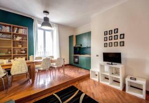 a living room with a table and chairs and a television at S. Peter Square Apartment in Rome