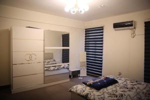 a bedroom with a bed and a large mirror at Karada Abu Nawas private room in Baghdad