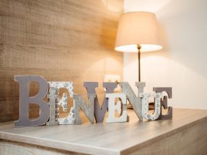 a wooden sign that says better sitting on a table at Appartement Am Hohenbusch in Burg-Reuland