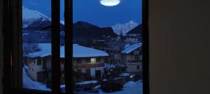 a view from a window of a city with snow covered mountains at Hotel Svanseti in Mestia