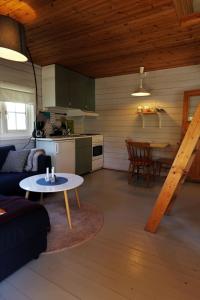 a living room with a couch and a table at Cabin "Rasberry" in beautiful Hardanger in Indre Alsåker