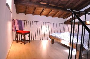 a bedroom with a bunk bed and a red chair at Sole Mio in Velletri