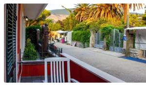 a white chair sitting on the side of a street at Дарина in Igalo