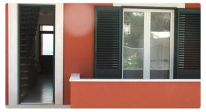 a window of a house with a red wall at Дарина in Igalo