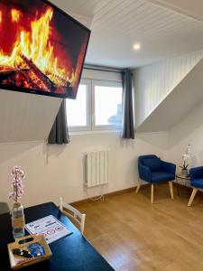 a living room with a fire on the wall at BLUE MOON in Saint-Nazaire +13 photos