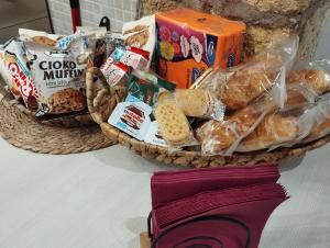 two baskets filled with bread and snacks on a counter at La casetta di Patry in Tarquinia