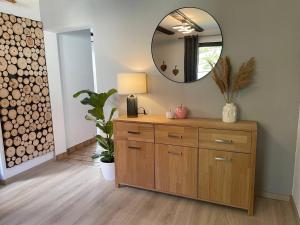 a dressing room with a mirror and a wooden dresser at HIRSCH Stadt Apartment 2 - Terrasse mit Flussblick - Parkplatz in Bad Harzburg