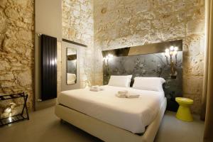 Postel nebo postele na pokoji v ubytování Isonzo Suites Relax
