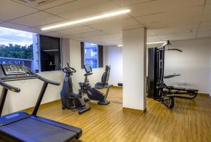 a gym with several exercise bikes in a room at Evian Thermas Residence in Caldas Novas