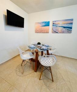 a dining room with a table and two chairs at Novaga Pto Morelos in Puerto Morelos