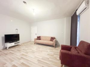 a living room with a couch and a television at Mukka Apart Hotel - شقق موكا الفندقية in Trabzon +10 photos