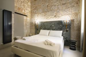 Postel nebo postele na pokoji v ubytování Isonzo Suites Relax + 16 fotografií