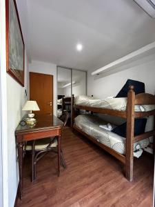 a bedroom with two bunk beds and a table at Tu Espacio in La Plata