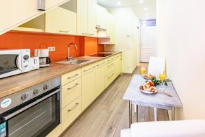 a kitchen with a table with a plate of food on it at GOLDEN LION APARTMENT by JR City Apartments in Vienna