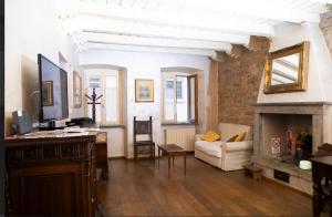 a living room with a couch and a fireplace at ST. JAMES HOME CITTÀ ALTA in Bergamo
