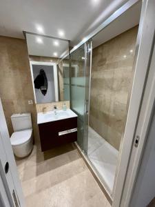 a bathroom with a shower and a toilet and a sink at Sinfonía Azul vistas al mar in Estepona +5 photos