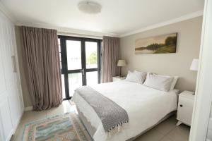 Ένα ή περισσότερα κρεβάτια σε δωμάτιο στο Lagoon Terrace 1