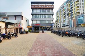 a group of motorcycles parked in front of a building at Hotel Regal Heaven in Pune