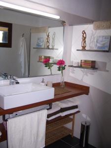 a bathroom with a white sink and a mirror at Casa El Mirador in Fuencaliente de la Palma