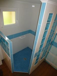 a bathroom with a shower with blue tile at AB Bel appartement 1 à 4 pers face vallée 3 étoiles WIFI in Le Tholy