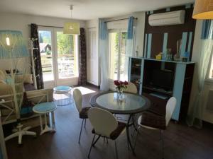 a living room with a glass table and chairs at AB Bel appartement 1 à 4 pers face vallée 3 étoiles WIFI in Le Tholy
