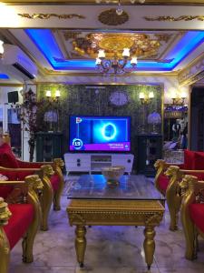 a living room with a tv and a table at Marko Paşa Konağı in Kusadası