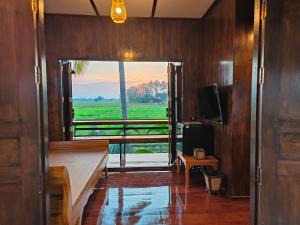 a hallway with a view of a room with a window at Shine Villa Sukhothai in Sukhothai