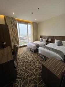 Postel nebo postele na pokoji v ubytování Rafid Hotel Jazan - فندق رفيد جازان