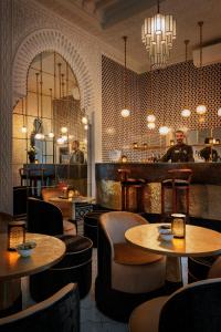 a restaurant with tables and chairs and a bar at Riad Kheirredine in Marrakesh +135 photos