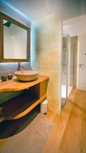 a bathroom with a sink and a mirror at La Maison d'Edouard Spa Chauffé Privé prés du Lac in Lanobre +38 photos