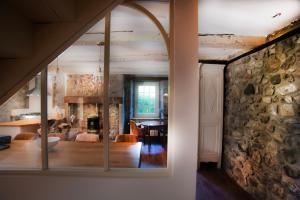 a room with a stone wall and a dining room at La Maison d'Edouard Spa Chauffé Privé prés du Lac in Lanobre