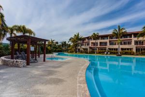 a view of the resort with a large swimming pool at El Tigre, Isla Palmares with Balcony & Shared Pool in Nuevo Vallarta 