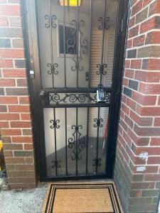 a door with a gate in a brick building at Your Home away from Home ! in Baychester