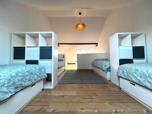 a room with two beds and a hallway at Bright and Modern Loft Retreat in Kehl am Rhein