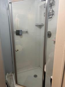 a shower with a glass door in a bathroom at Your Home away from Home ! in Baychester