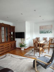 a living room with a dining room table and chairs at Apartamento vacacional Meira in Meira