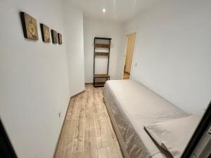 a bedroom with a bed and a wooden floor at Sinfonía Azul vistas al mar in Estepona