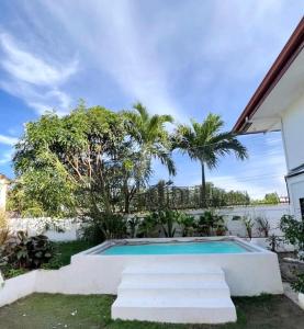 a swimming pool in the backyard of a house at NEW Exclusive Luxury Pool Villa in Mactan Island +27 photos