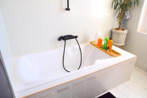 a bathroom with a bath tub with a faucet at Quartier Chic l Chambres l Gare centrale l Tramway in Nice +33 photos