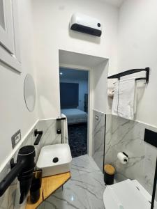 a white bathroom with a sink and a toilet at Luxury Sweet Dreams-Napoli in San Vitaliano  +9 photos