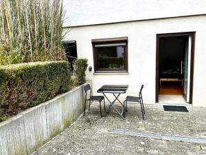 a table and two chairs in front of a house at PREMIUM HOME in Busingen am Hochrhein
