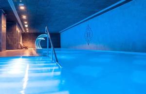 an empty swimming pool with stairs in a building at New CP Luxury studio with spa in Gibraltar