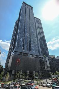 a tall building with cars parked in a parking lot at STAR Residences Popular By KLCC in Kuala Lumpur
