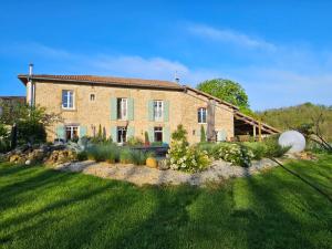 a large brick house with a grass yard at Au contact de la nature in Chatuzange-le-Goubet