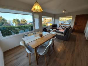 a living room with a table and chairs and a couch at Andalue in San Carlos de Bariloche