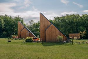 a large wooden building in a field of grass at Zen Sasino in Sasino