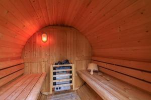 a sauna with two benches in a wooden room at Ferienhaus Sissi - Wellness-Paradies in ruhiger Lage mit Whirlpool und Sauna in Großschönau